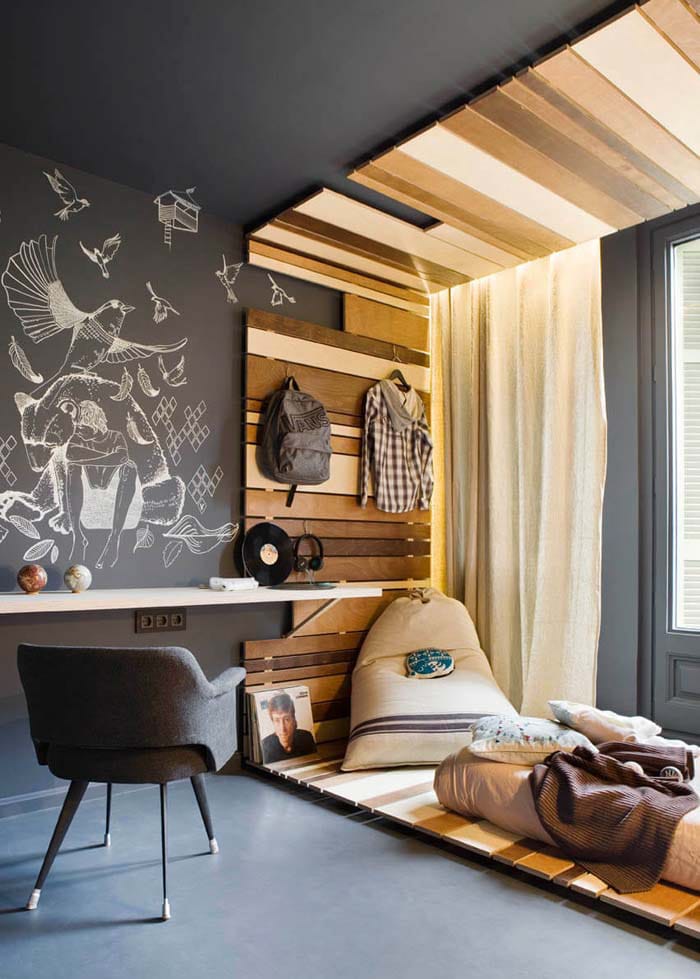 An artistic room with a chalkboard wall, hand-drawn artwork, and wooden accents.